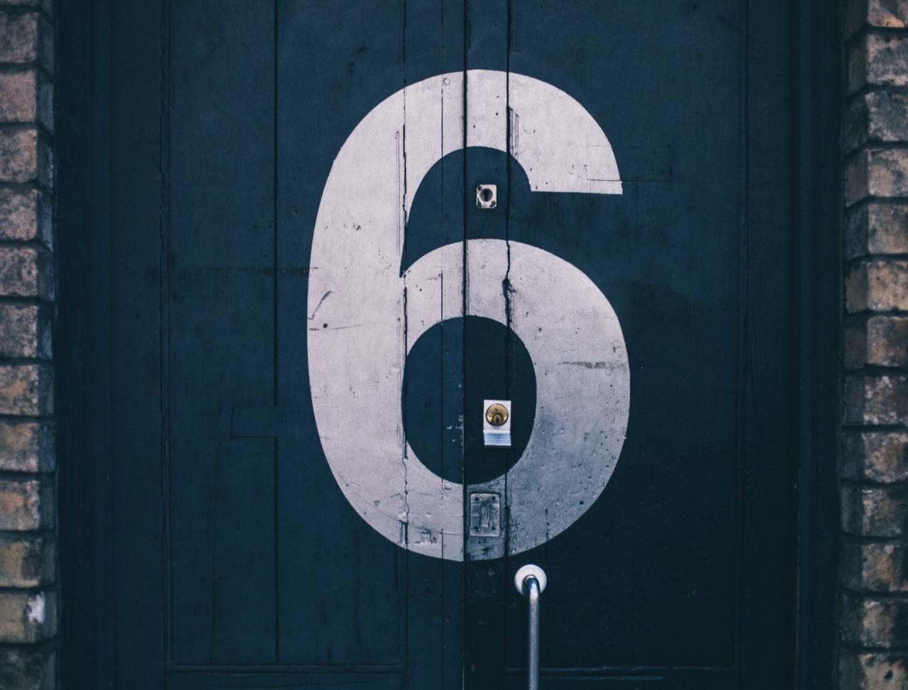 Door with the number six painted on it